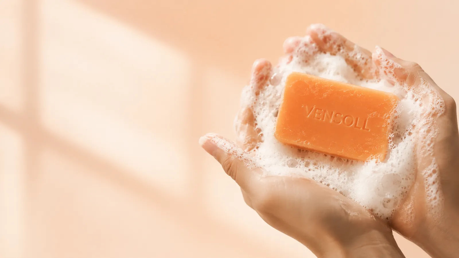 Close-up of Vensoll Japanese persimmon soap bar and lather